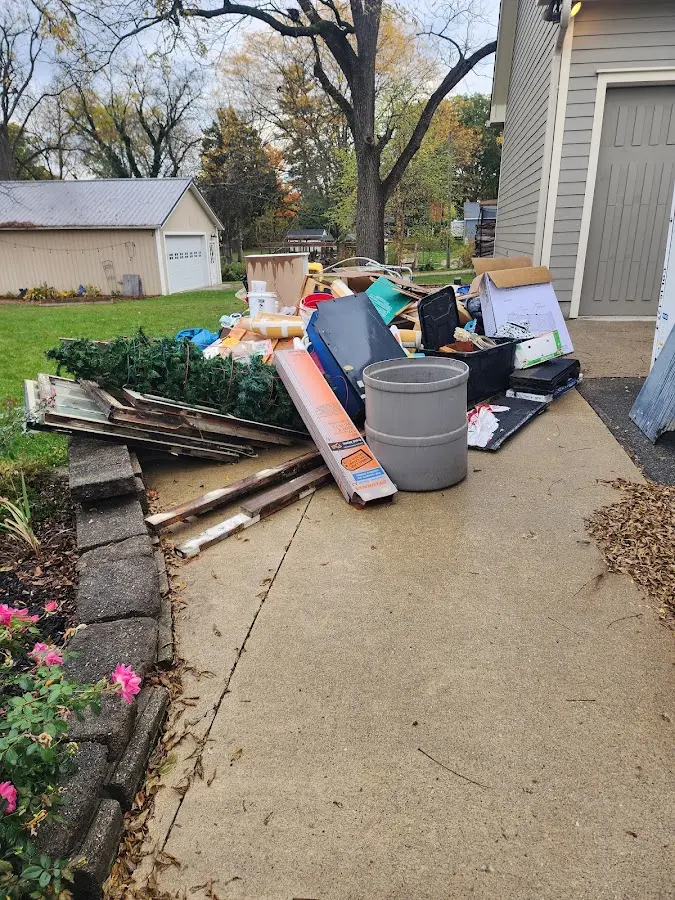 Dumpster being loaded with debris for 3 Yard Dumpster Rental in Katy